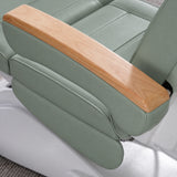 Manufakturo Grace Olive electric beauty bed armrest detail, showing the natural wooden top and matching upholstered side cushions.