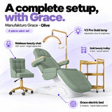 Manufakturo Grace Olive four-piece salon set features: three-motor electric bed with hand-held control, Noblesse swivel chair, adjustable V3 Pro Gold lamp and three-tier gold trolley.