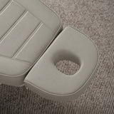 Manufakturo Grace Pearl Greige electric beauty bed headrest detail, showing the open massage face hole and matching stitched upholstery.