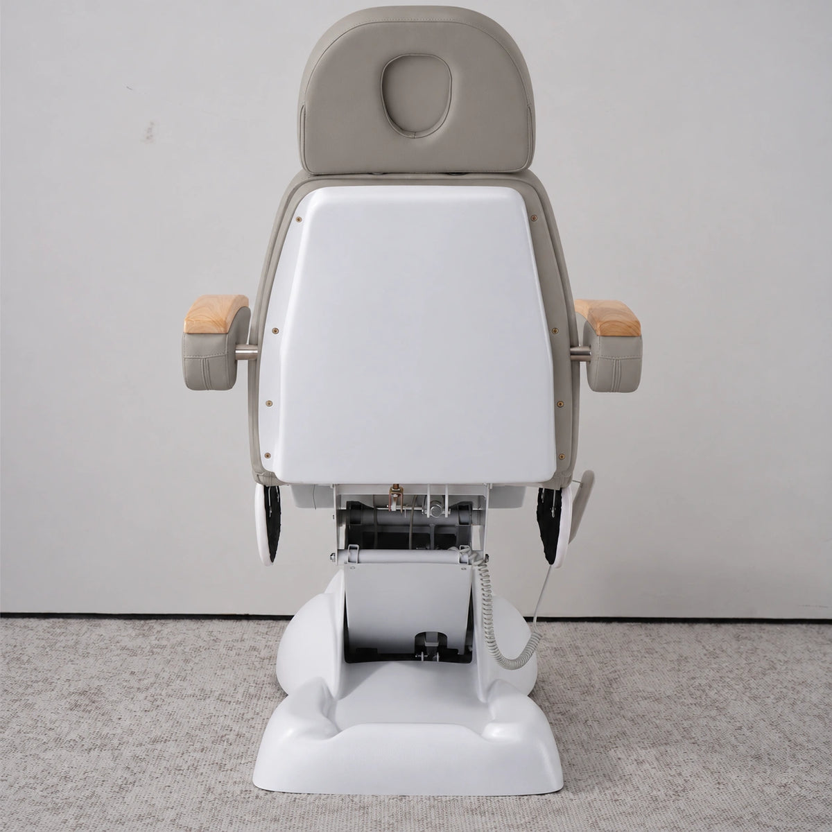 Rear view of the Manufakturo Grace Pearl Greige electric beauty bed, showing the upholstered headrest, white rigid rear cover and adjustment mechanism.