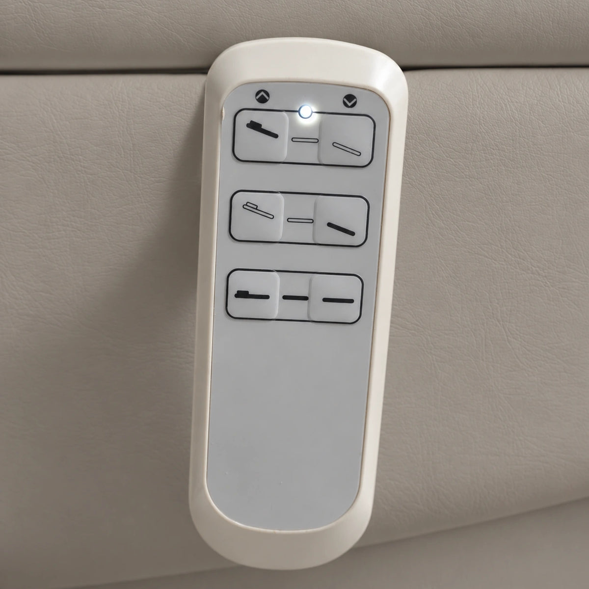 Manufakturo Grace Pearl Greige electric beauty bed hand-held control with the original buttons and indicator, against matching upholstery.