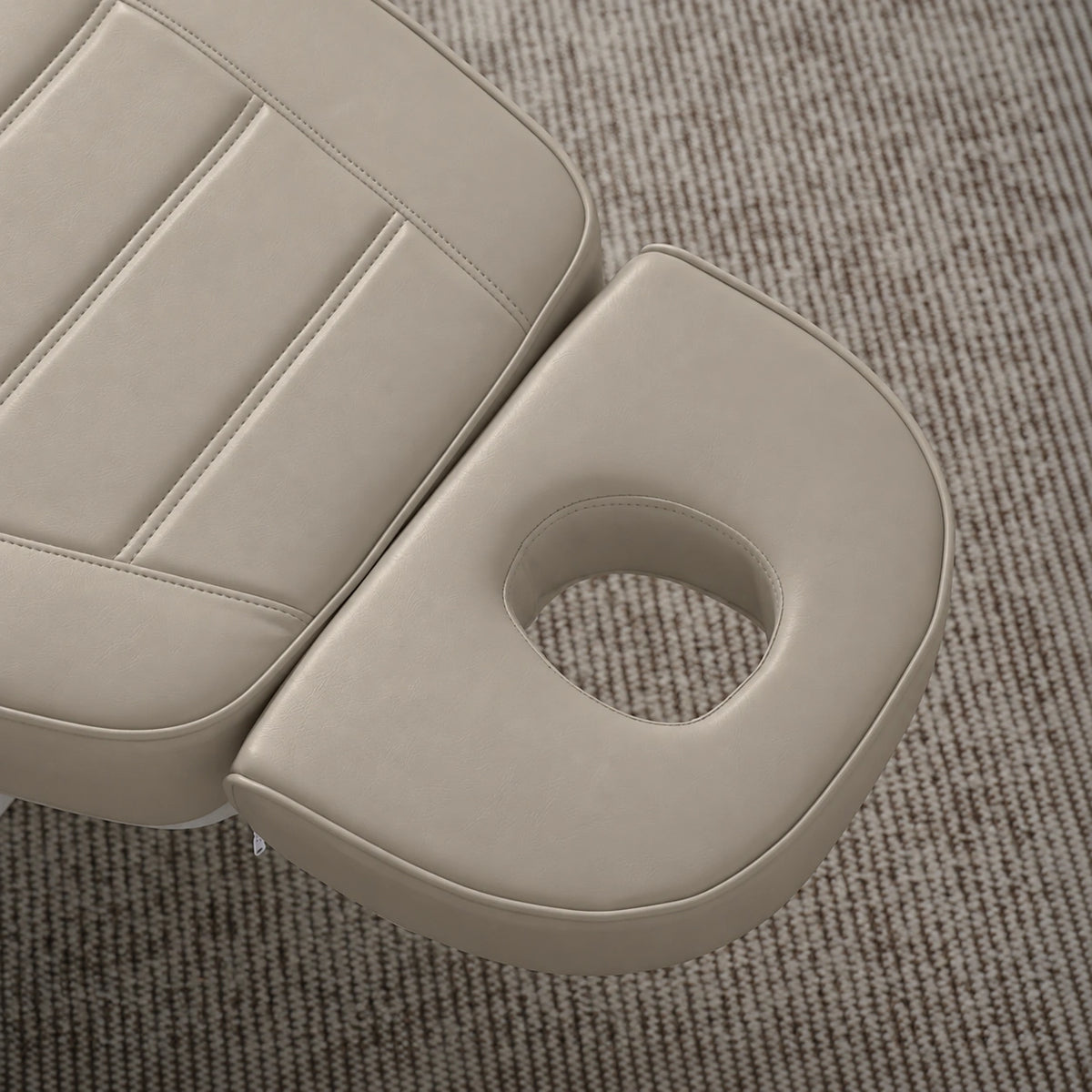 Manufakturo Grace Stone Taupe electric beauty bed headrest detail, showing the open massage face hole and matching stitched upholstery.