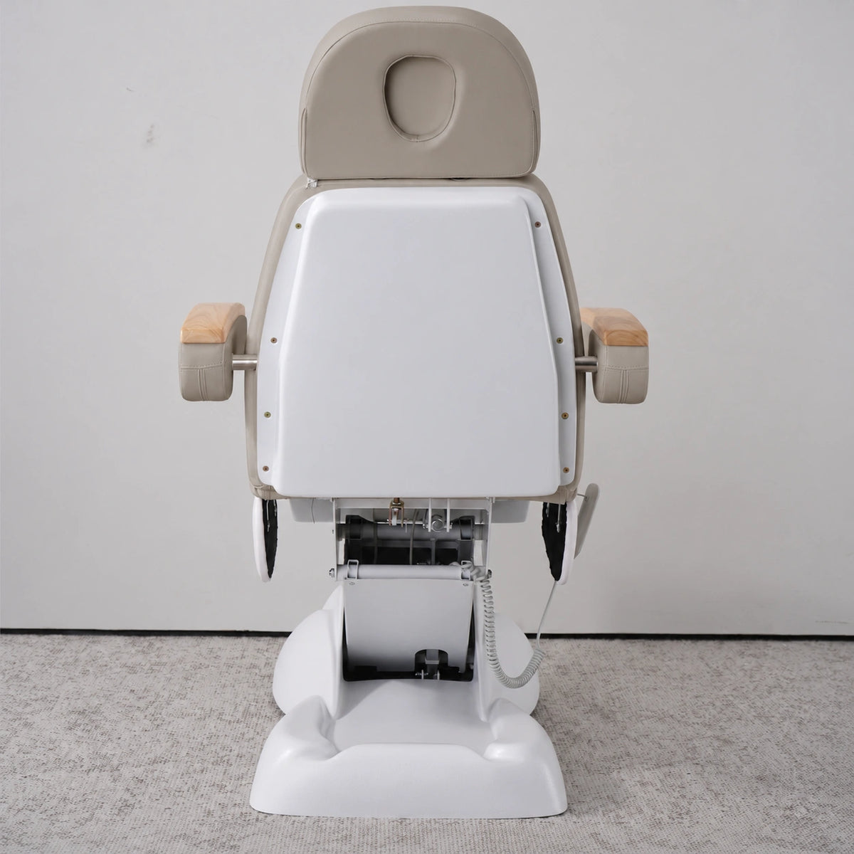 Rear view of the Manufakturo Grace Stone Taupe electric beauty bed, showing the upholstered headrest, white rigid rear cover and adjustment mechanism.