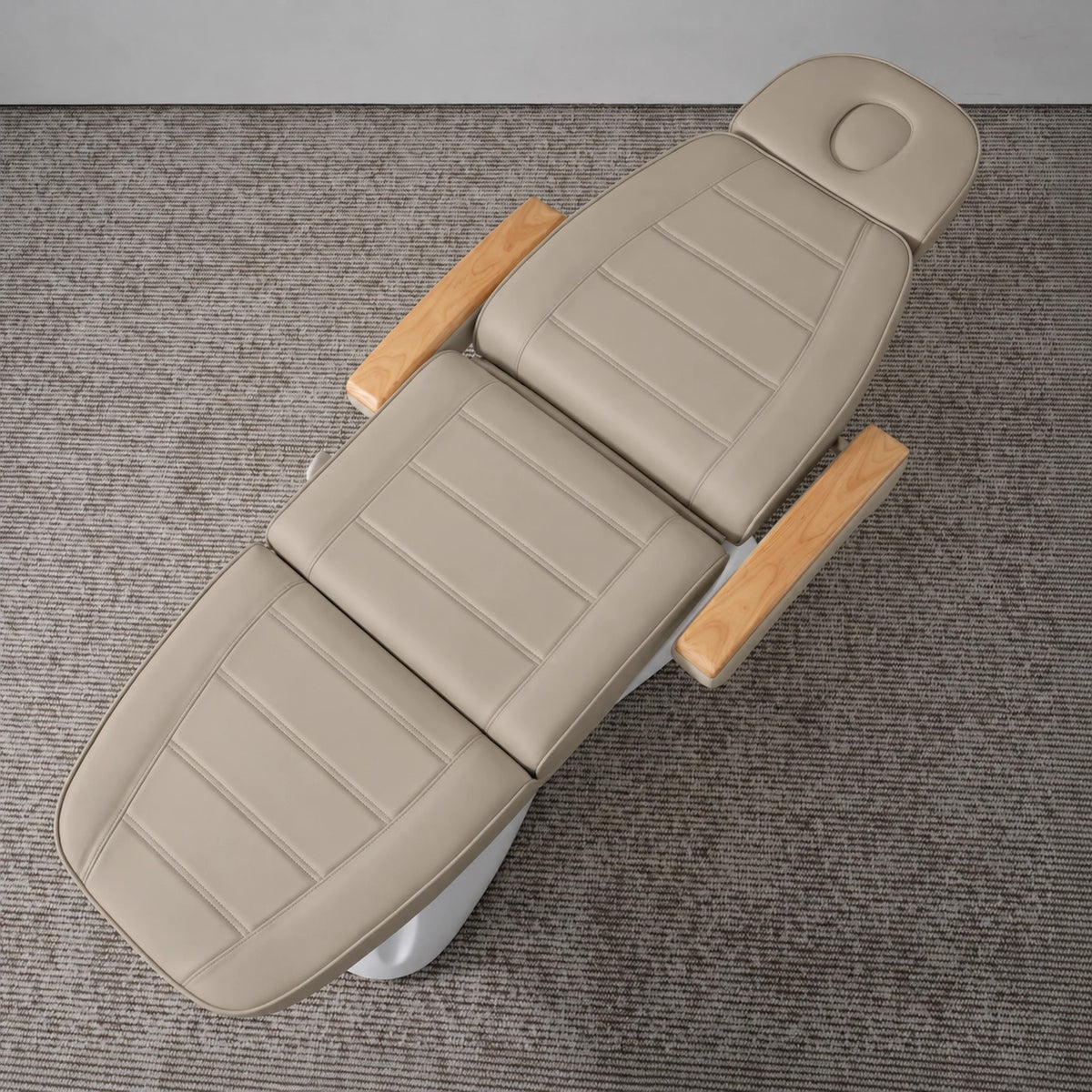 Manufakturo Grace Stone Taupe electric beauty bed viewed from above, showing the segmented upholstery, face insert and wooden armrest caps.