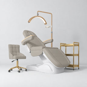 Manufakturo Grace Stone Taupe complete salon set with electric beauty bed, Noblesse chair, V3 Pro Gold treatment lamp and three-tier gold trolley.