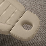 Manufakturo Grace Warm Beige electric beauty bed headrest detail, showing the open massage face hole and matching stitched upholstery.