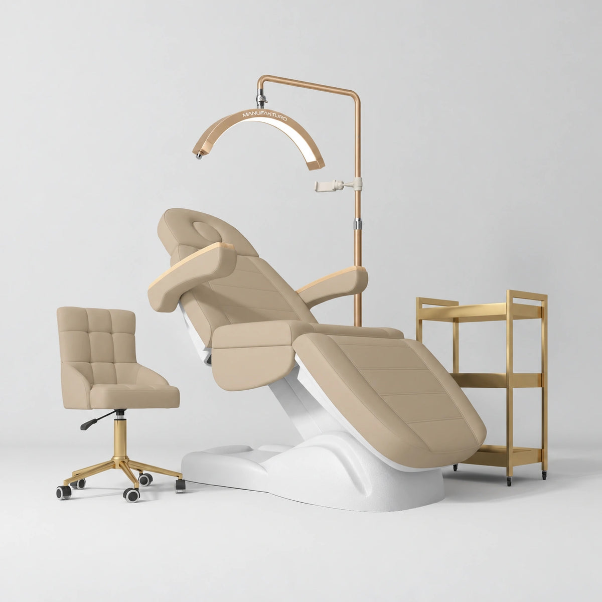 Manufakturo Grace Warm Beige complete salon set with electric beauty bed, Noblesse chair, V3 Pro Gold treatment lamp and three-tier gold trolley.