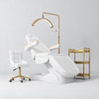 Manufakturo Grace White complete salon set with electric beauty bed, Noblesse chair, V3 Pro Gold treatment lamp and three-tier gold trolley.