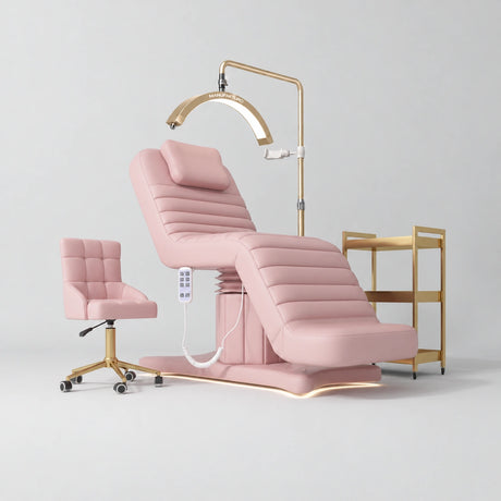 Manufakturo Grandeur Bare Blush complete studio set with beauty bed, Noblesse chair, gold trolley and V3 Pro Gold treatment lamp, photographed against the original grey studio background.