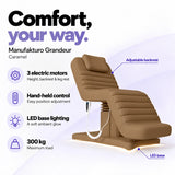 Manufakturo Grandeur Caramel electric beauty bed with 3 motors for height, backrest and leg rest adjustment, hand-held control, LED base lighting and 300 kg maximum load.