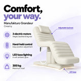 Manufakturo Grandeur Creamy electric beauty bed with 3 motors for height, backrest and leg rest adjustment, hand-held control, LED base lighting and 300 kg maximum load.