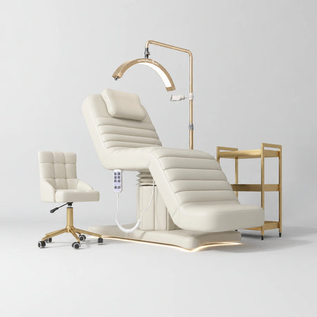 Manufakturo Grandeur Creamy complete studio set with beauty bed, Noblesse chair, gold trolley and V3 Pro Gold treatment lamp, photographed against the original grey studio background.