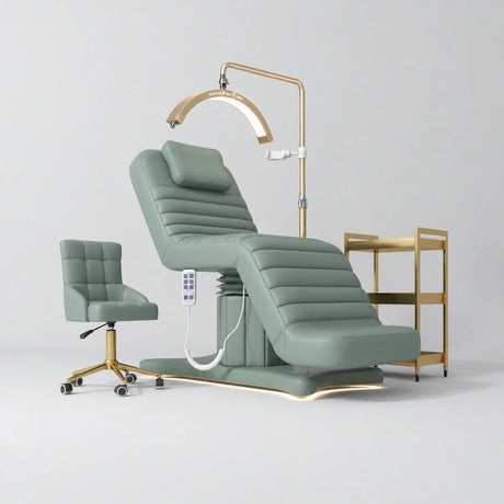 Manufakturo Grandeur Olive complete studio set with beauty bed, Noblesse chair, gold trolley and V3 Pro Gold treatment lamp, photographed against the original grey studio background.