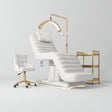 Manufakturo Grandeur White complete studio set with beauty bed, Noblesse chair, gold trolley and V3 Pro Gold treatment lamp, photographed against the original grey studio background.