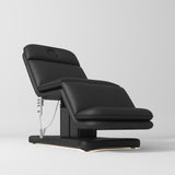 Manufakturo Heated Imperial Signature Electric Beauty Bed Black - displayed in a professional treatment-room setting