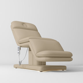 Manufakturo Heated Imperial Signature Electric Beauty Bed Warm Beige - displayed in a professional treatment-room setting