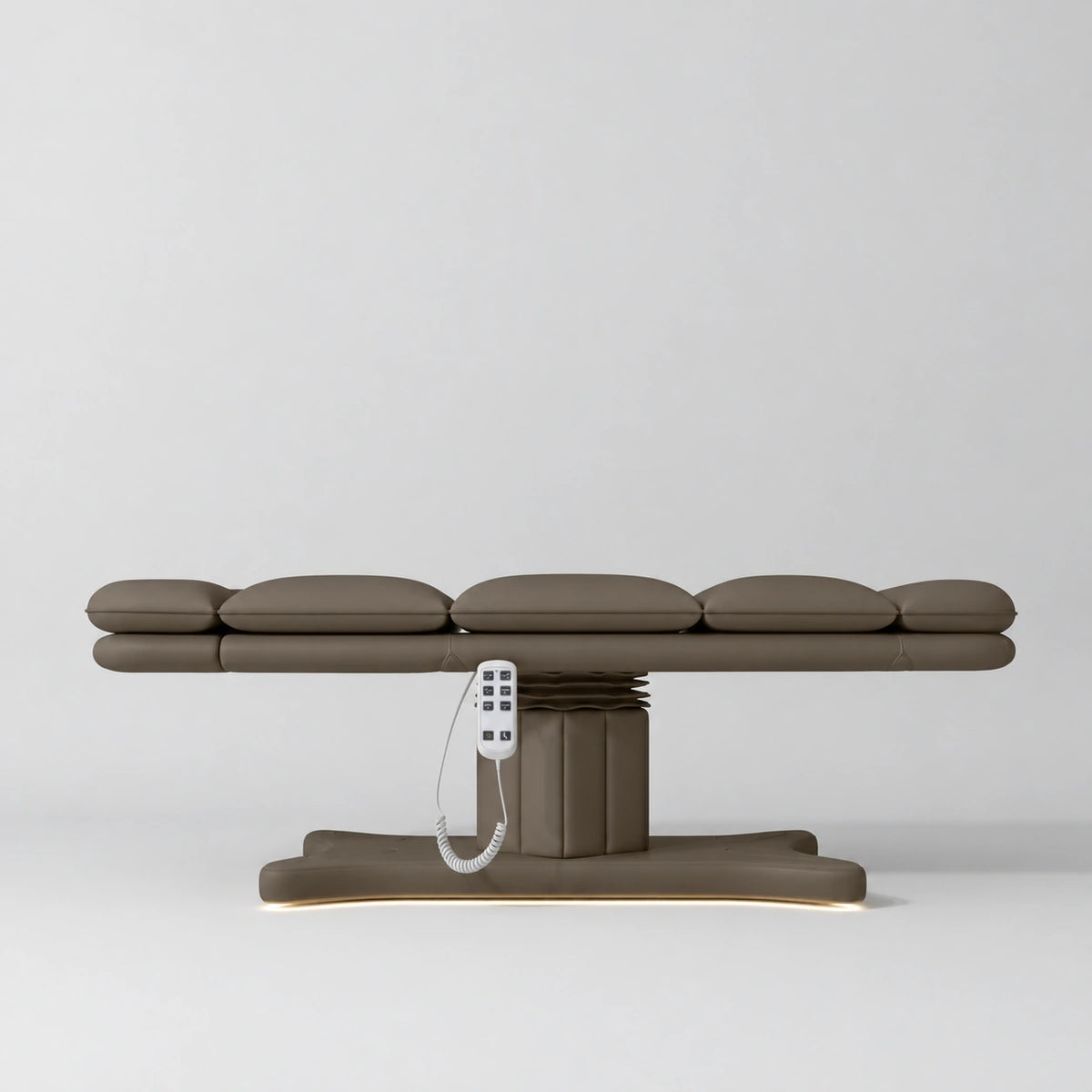 Manufakturo Imperial Signature heated electric beauty bed in Cocoa Mocha, shown fully flat from the side with matching base and white remote control.