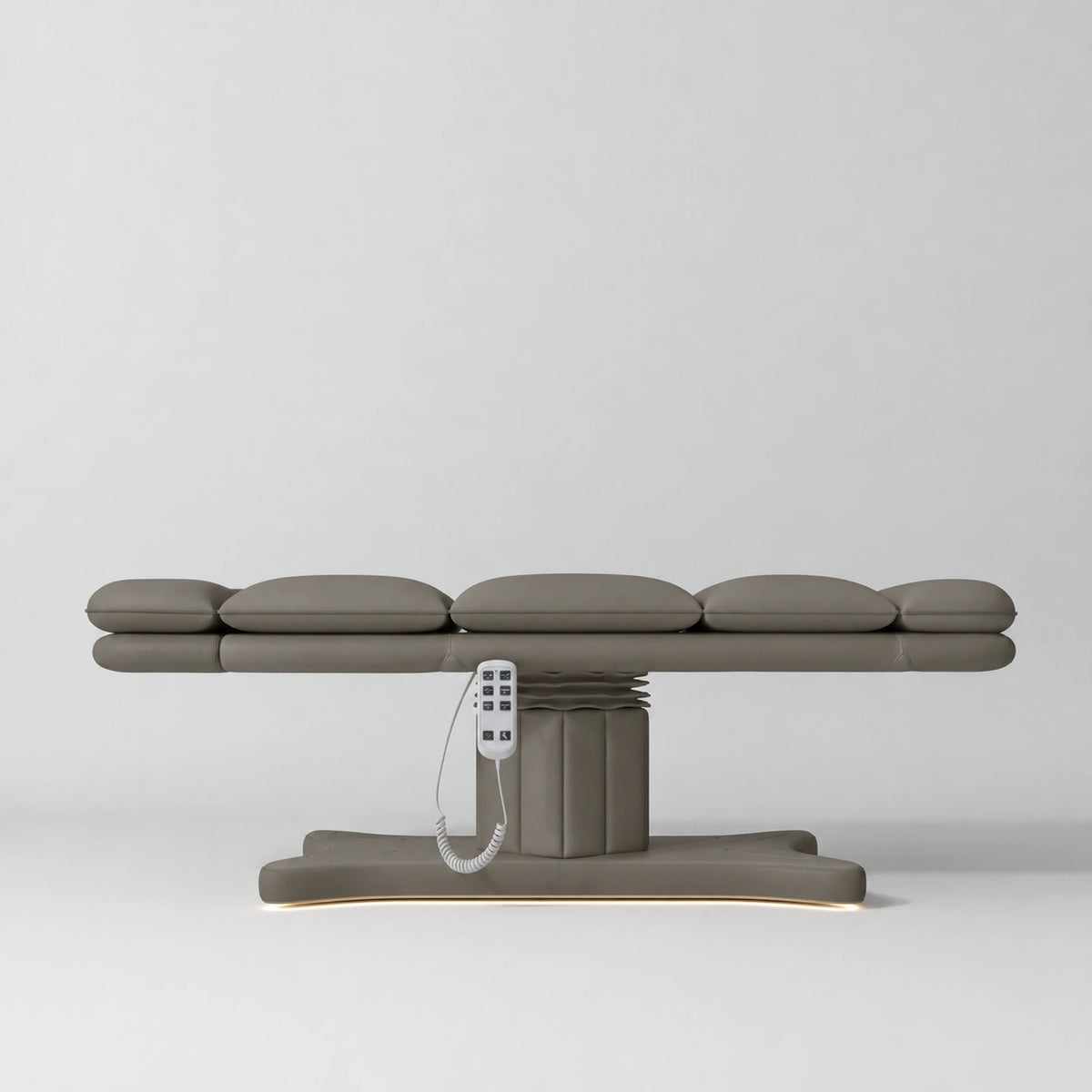 Manufakturo Imperial Signature Deep Ash heated beauty bed fully flat in side view, showing smooth segmented upholstery, hand-held control and illuminated matching base.