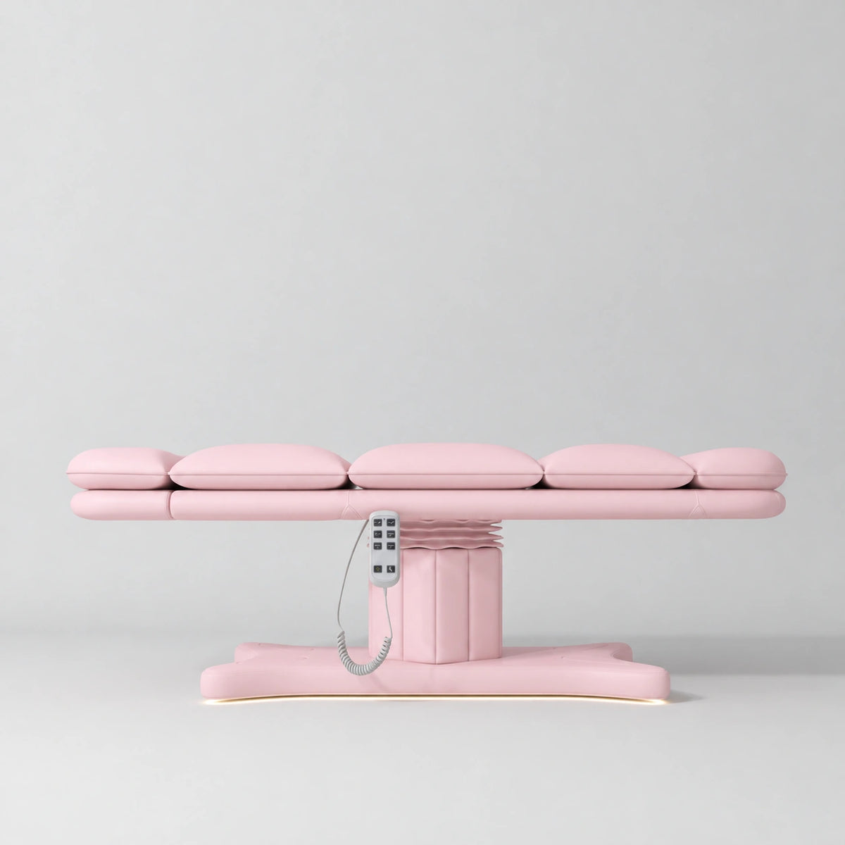 Manufakturo Imperial Signature heated electric beauty bed in Light Pink, shown fully flat from the side with matching base and white remote control.