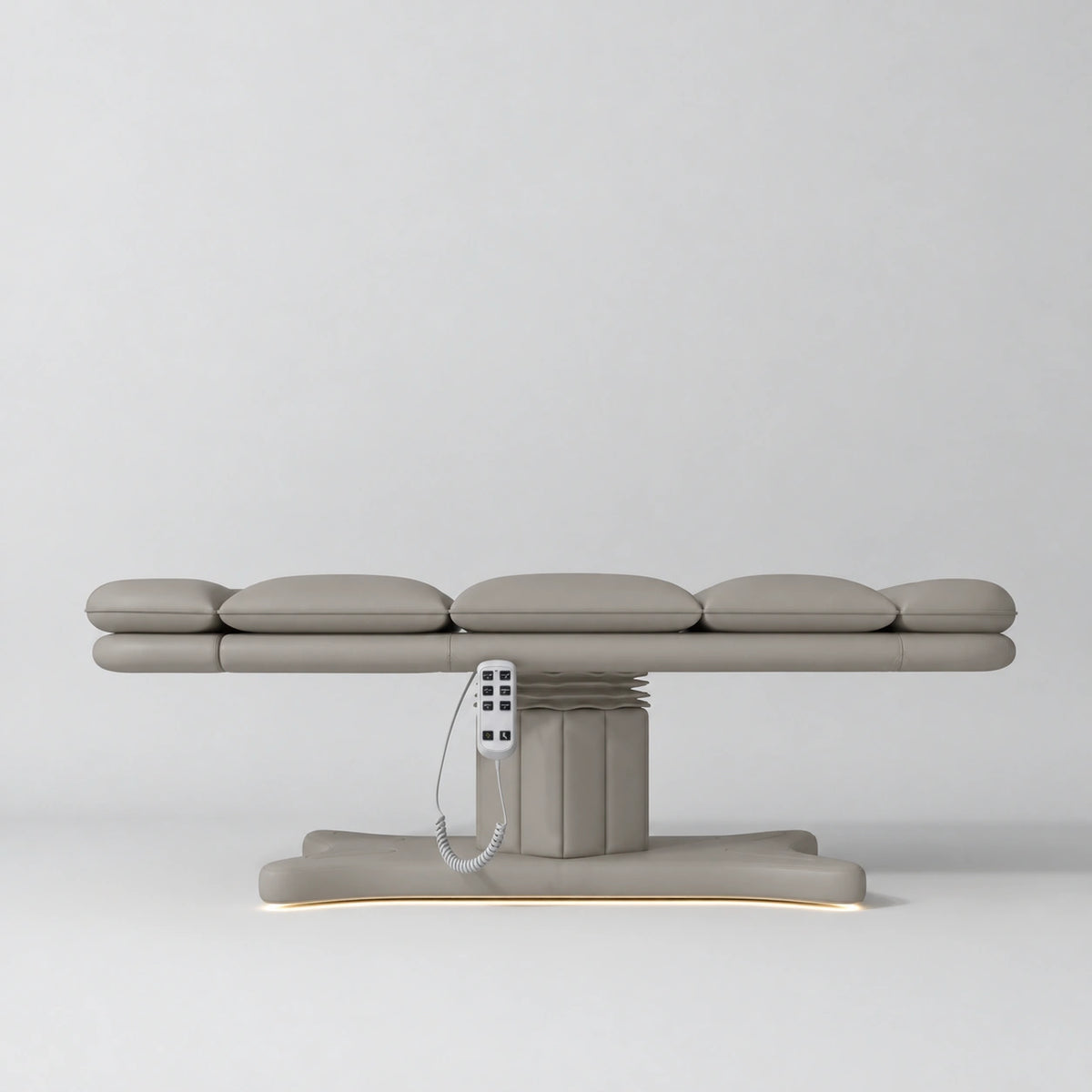 Manufakturo Imperial Signature heated electric beauty bed in Pearl Greige, shown fully flat from the side with matching base and white remote control.