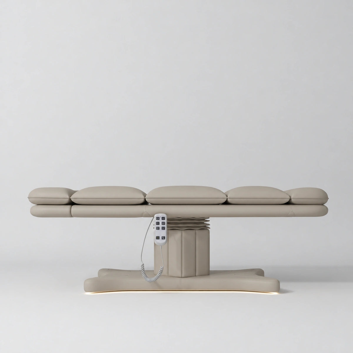 Manufakturo Imperial Signature Stone Taupe heated beauty bed fully flat in side view, showing smooth segmented upholstery, hand-held control and illuminated matching base.