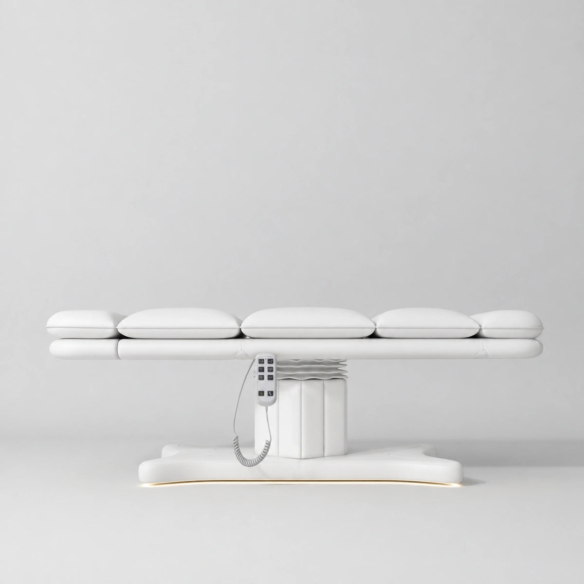 Manufakturo Imperial Signature White heated beauty bed fully flat in side view, showing smooth segmented upholstery, hand-held control and illuminated matching base.