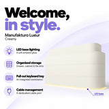 Manufakturo Lueur Creamy reception desk with LED base lighting, organised drawer, cabinet and file storage, a pull-out keyboard tray and dedicated cable port.
