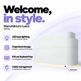 Manufakturo Lueur White reception desk with LED base lighting, organised drawer, cabinet and file storage, a pull-out keyboard tray and dedicated cable port.