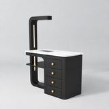 Three-quarter view of the Manufakturo ManiMuse Black manicure desk with a white stone top, dust collector and four drawers.