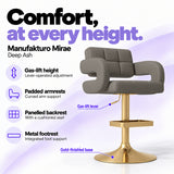 Manufakturo Mirae Deep Ash salon and reception bar stool with lever-operated gas-lift height adjustment, padded curved armrests, a panelled backrest, cushioned seat, integrated metal footrest and gold-finished pedestal base.