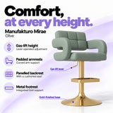 Manufakturo Mirae Olive salon and reception bar stool with lever-operated gas-lift height adjustment, padded curved armrests, a panelled backrest, cushioned seat, integrated metal footrest and gold-finished pedestal base.
