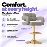 Manufakturo Mirae Pearl Greige salon and reception bar stool with lever-operated gas-lift height adjustment, padded curved armrests, a panelled backrest, cushioned seat, integrated metal footrest and gold-finished pedestal base.