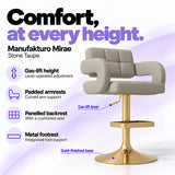 Manufakturo Mirae Stone Taupe salon and reception bar stool with lever-operated gas-lift height adjustment, padded curved armrests, a panelled backrest, cushioned seat, integrated metal footrest and gold-finished pedestal base.