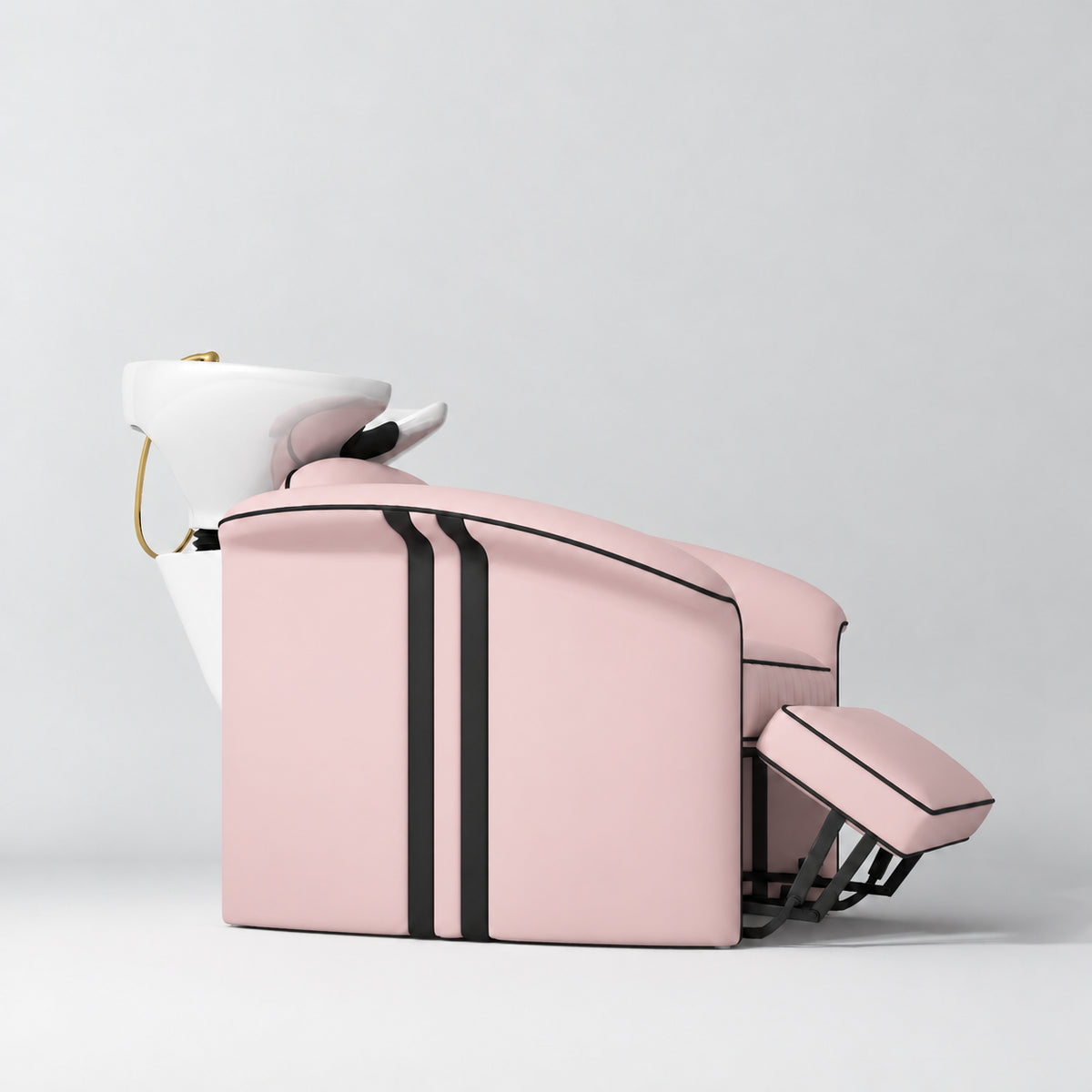 Manufakturo Monaco Bare Blush backwash unit with white basin and extended electric leg rest, shown from a low side angle.