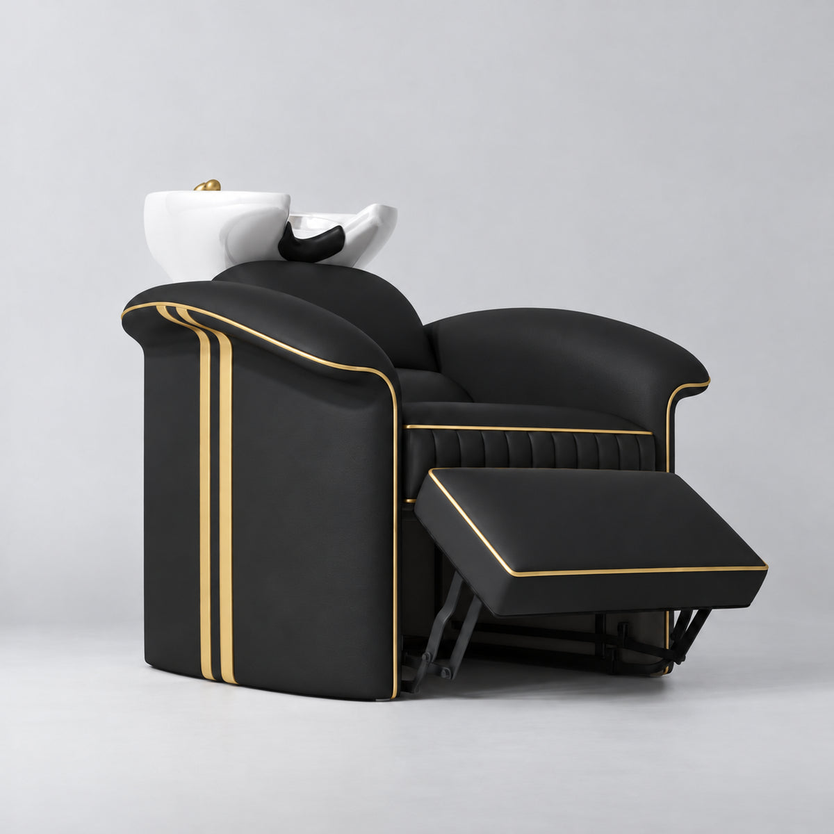 Manufakturo Monaco Black backwash unit with gold trim, white basin and extended electric leg rest, viewed from the front at an angle.