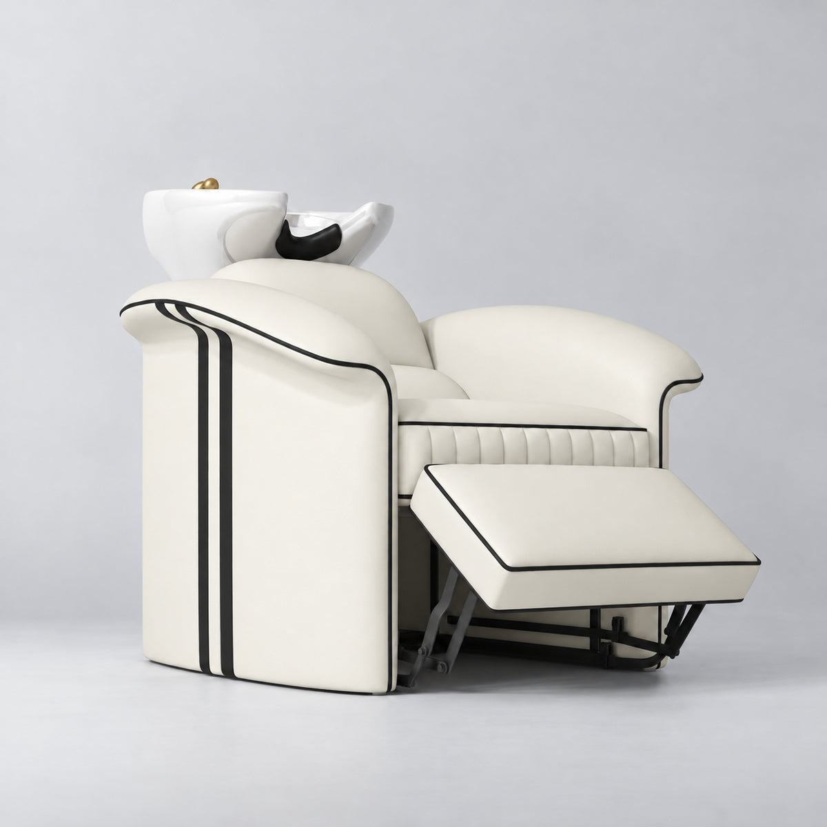 Manufakturo Monaco Creamy backwash unit with white basin and extended electric leg rest, viewed from the front at an angle.