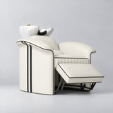 Manufakturo Monaco Creamy backwash unit with white basin and extended electric leg rest, viewed from the front at an angle.