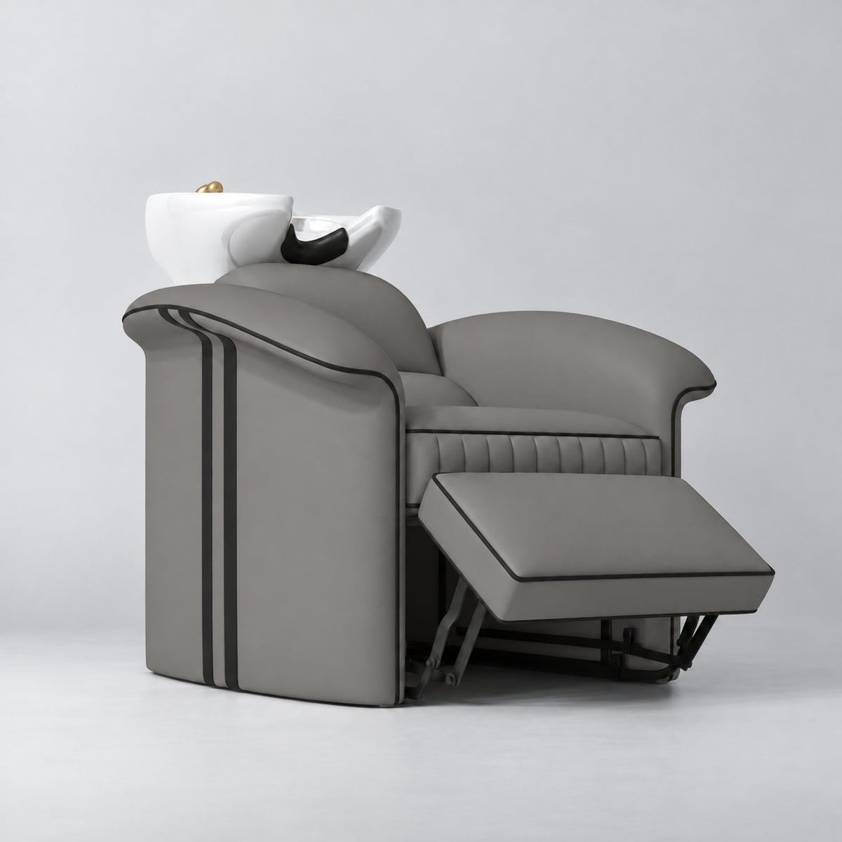 Manufakturo Monaco Deep Ash backwash unit with white basin and extended electric leg rest, viewed from the front at an angle.