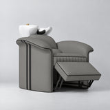Manufakturo Monaco Deep Ash backwash unit with white basin and extended electric leg rest, viewed from the front at an angle.