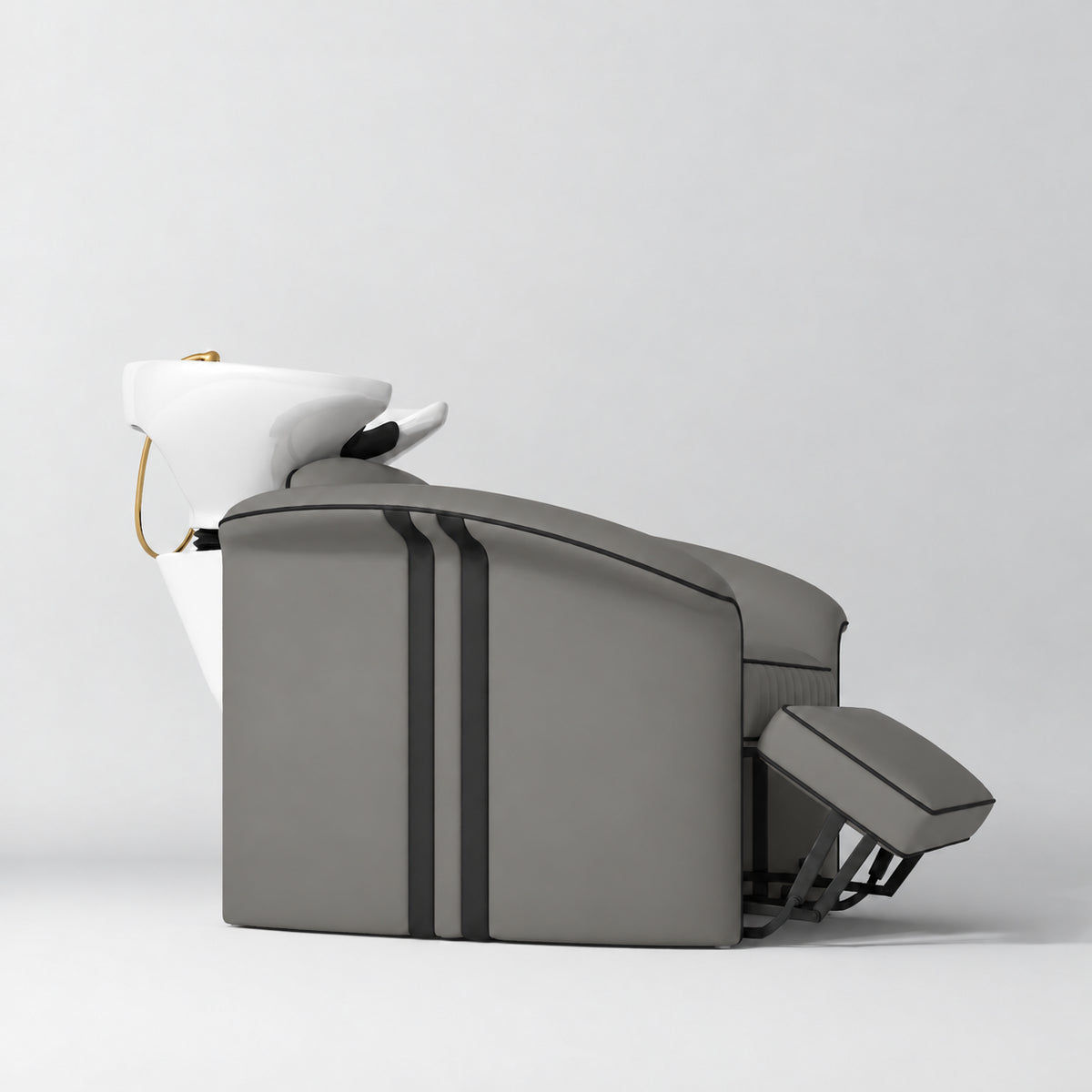 Manufakturo Monaco Deep Ash backwash unit with white basin and extended electric leg rest, shown from a low side angle.