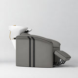 Manufakturo Monaco Deep Ash backwash unit with white basin and extended electric leg rest, shown from a low side angle.