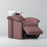 Manufakturo Monaco Dusty Rose backwash unit with white basin and extended electric leg rest, viewed from the front at an angle.