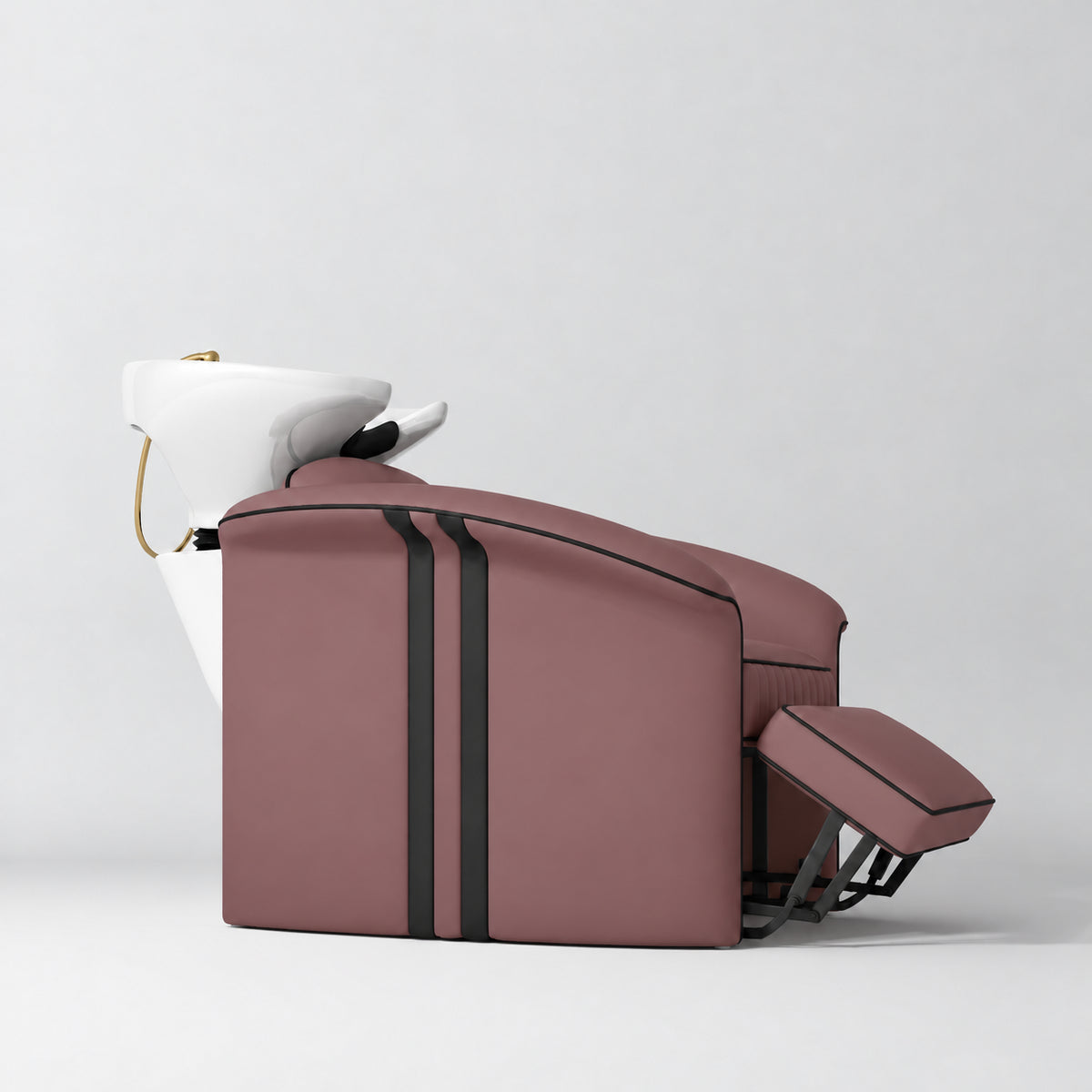 Manufakturo Monaco Dusty Rose backwash unit with white basin and extended electric leg rest, shown from a low side angle.