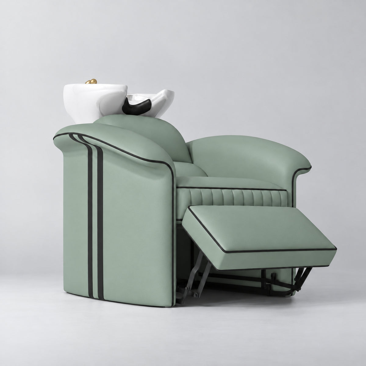 Manufakturo Monaco Olive backwash unit with white basin and extended electric leg rest, viewed from the front at an angle.