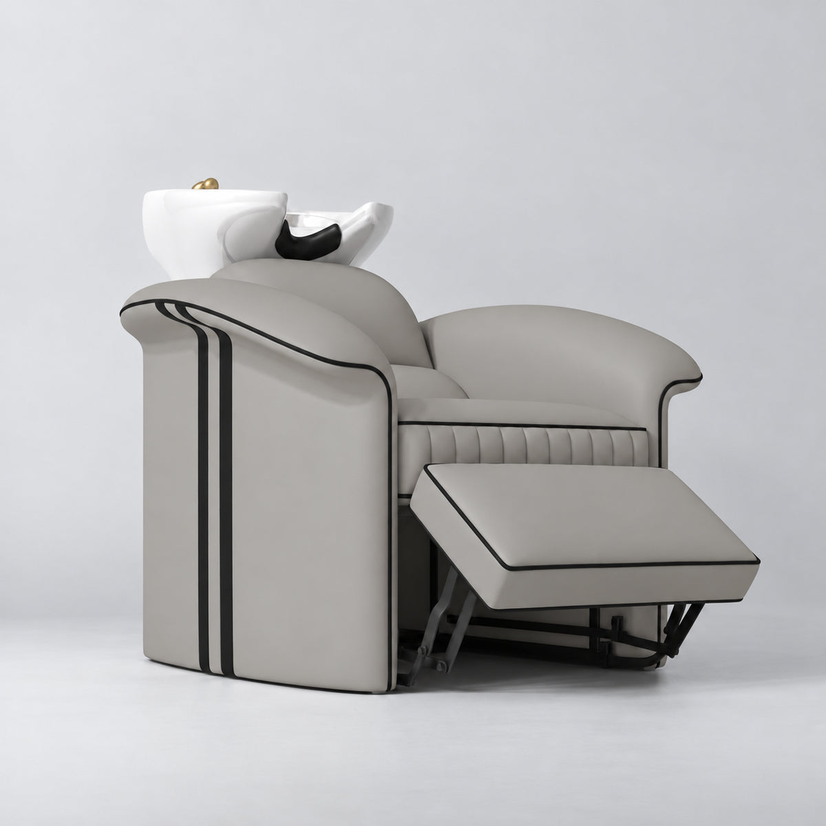 Manufakturo Monaco Pearl Greige backwash unit with white basin and extended electric leg rest, viewed from the front at an angle.