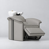 Manufakturo Monaco Pearl Greige backwash unit with white basin and extended electric leg rest, viewed from the front at an angle.