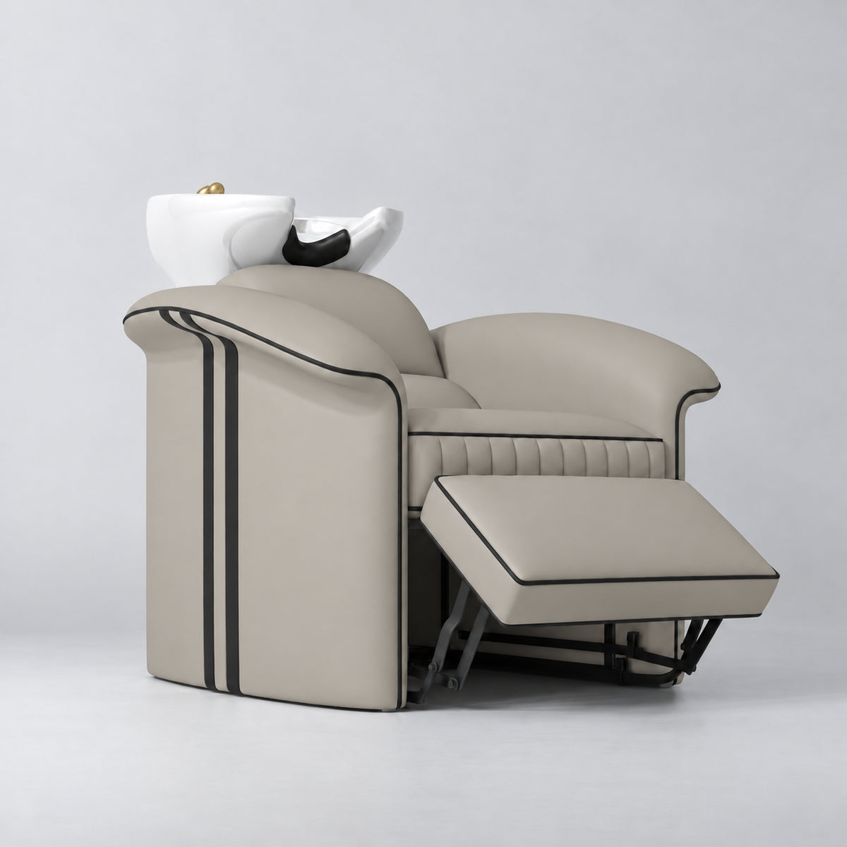 Manufakturo Monaco Stone Taupe backwash unit with white basin and extended electric leg rest, viewed from the front at an angle.
