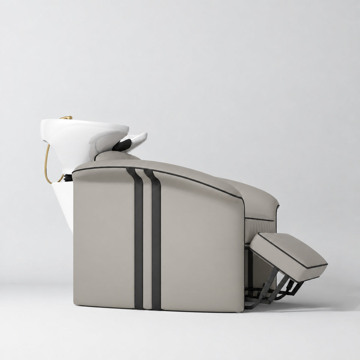 Manufakturo Monaco Stone Taupe backwash unit with white basin and extended electric leg rest, shown from a low side angle.