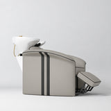 Manufakturo Monaco Stone Taupe backwash unit with white basin and extended electric leg rest, shown from a low side angle.