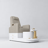 Manufakturo Noémie Stone Taupe electric pedicure chair with massage backrest, gold tap, empty ceramic basin and smooth white foot support.